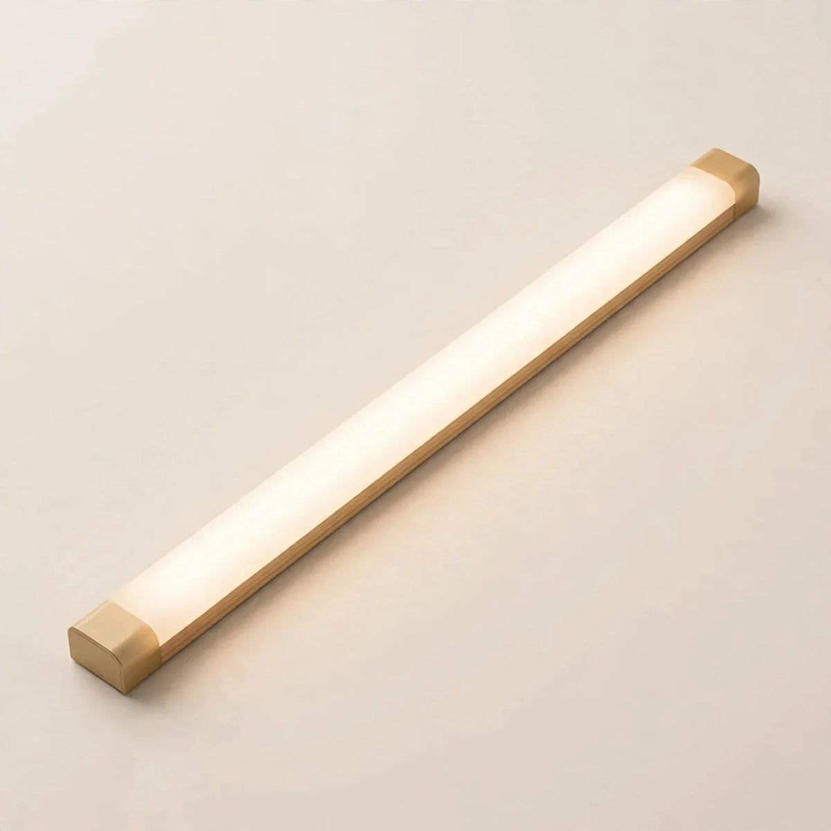 Motion sensor LED cabinet light bar glowing warm white — front view