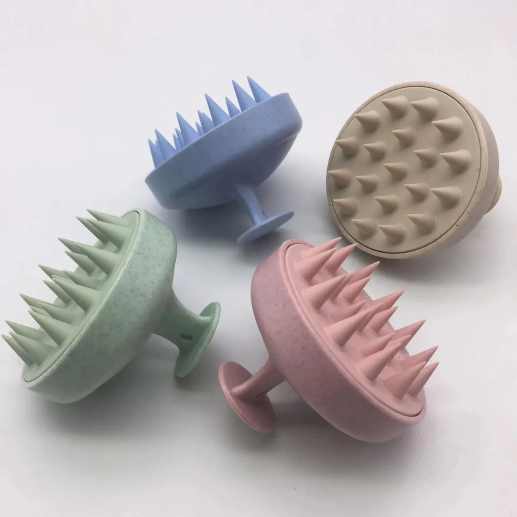 Scalp massagers in mint, light blue, pink, and beige — color flat lay