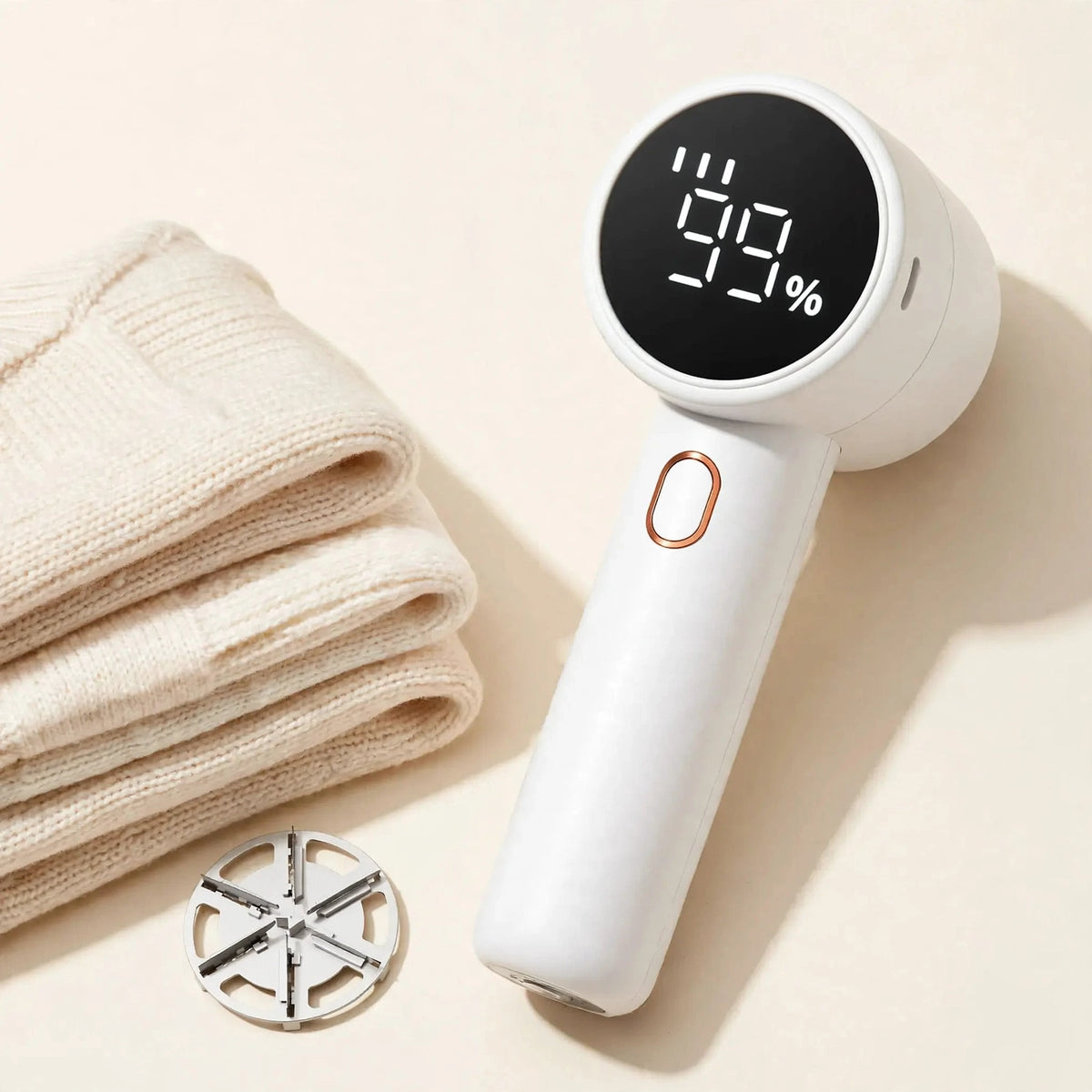 Fabric shaver with folded sweaters and spare 6-leaf blade