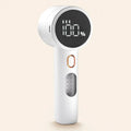 White rechargeable fabric shaver with LED battery display — studio hero shot